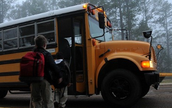 students loading on school bus